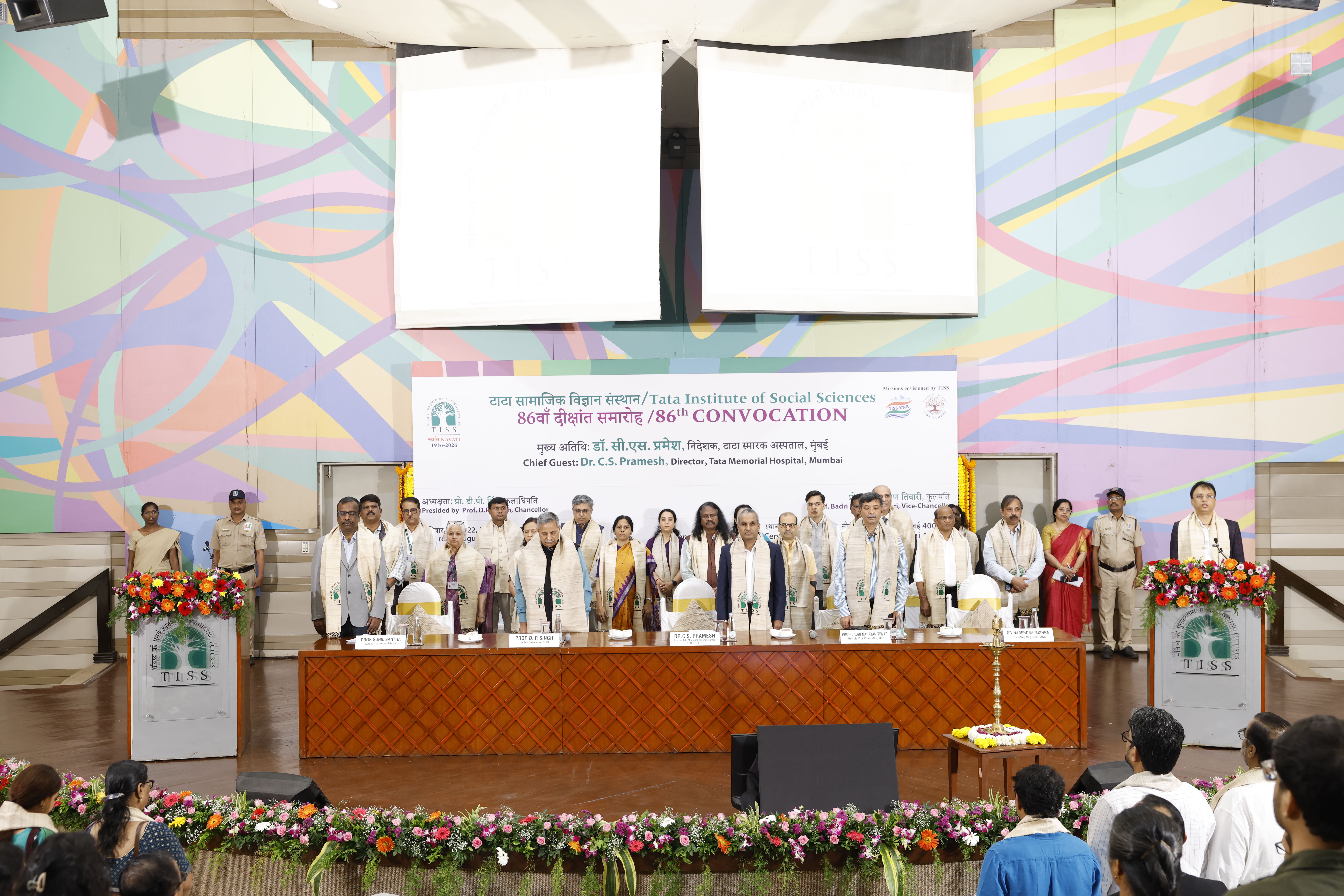 Graduating students standing during the national anthem