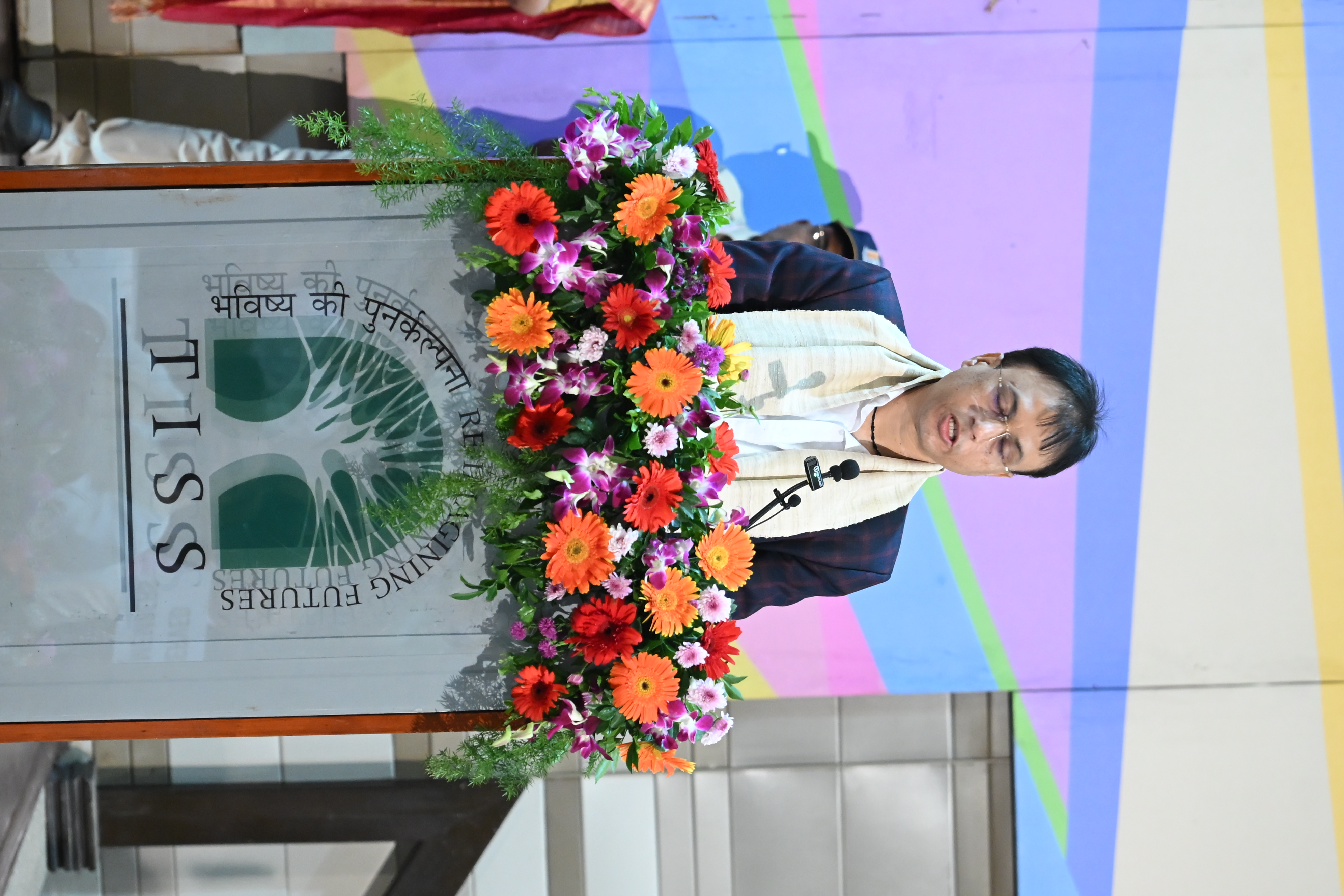 Registrar addressing the convocation gathering at the podium