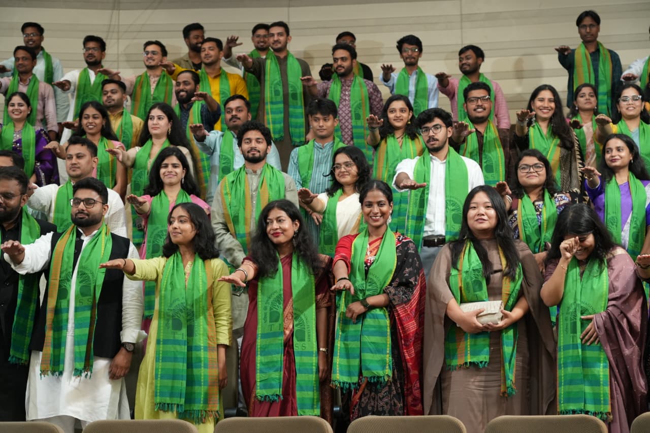 Graduating students standing during the administration of the oath